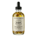 Glass bottle of Luna & Co. Soapery Brigid body oil with a dropper on a white background