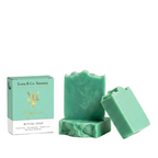 Green soap bars with packaging on a white background