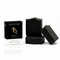 Black soap bars with packaging on a white background