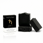 Black soap bars with packaging on a white background