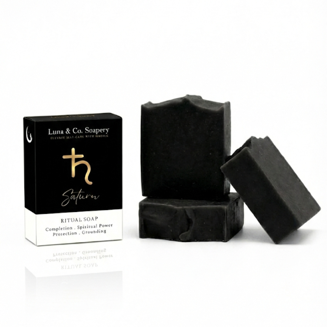 Black soap bars with packaging on a white background