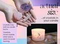 Two hands hold three actual-size crystals—amethyst, rose quartz, and clear quartz—above THE MINDFUL COLLECTIVE Air Elements Candle 12oz. Text notes crystals may shift as the candle burns; handle with care.