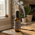 Bottle of Altard Goods diffuser with incense on a wooden table in a home setting