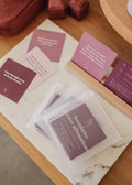 JaxKellys Shower Affirmation™ Cards - Boundaries, in pink and purple shades, are displayed on a marble tray and wooden surface with visible messages about boundaries, self-care, and mental health.