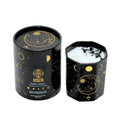 A black octagonal Earths Elements Wholesale Crystal Candle, Moon Phase (pack of 6), with gold moon and star designs, features a white candle topped with Black Obsidian crystals and comes in a matching box labeled Manifestation & Setting.
