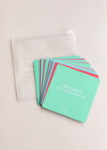 JaxKelly’s Shower Affirmation™ Cards - Teens are displayed fanned out on a light surface, with the top card reading “I bring value to the world around me,” beside a translucent pouch featuring a smiley face design.