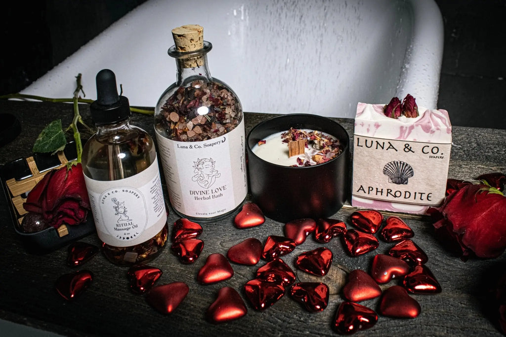 Create a romantic bath with Luna & Co. Soapery’s Divine Love Ritual Kit—includes bath oil, herbal soak, candle, soap, red rose petals, and shiny heart decor—for the perfect love ritual or self-care by your tub.