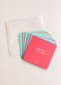 JaxKelly’s Shower Affirmation™ Cards – Teens are colorful square cards with uplifting messages, shown fanned out beside a translucent pouch featuring a smiley face and white text.